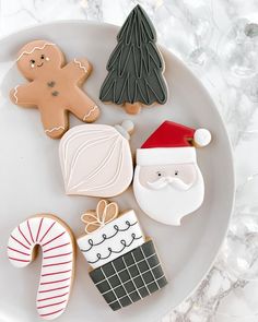 decorated christmas cookies on a plate with santa clause