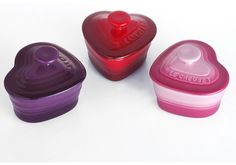 three heart shaped containers sitting next to each other