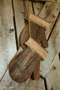 an old wooden object is hanging from a rope on the floor with wood planks