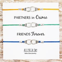 "L I S T I N G * I N C L U D E S: * THREE charm bracelets presented on ONE accompanying message card * Message card text: \"Partners in Crime / Friends Forever\" * Select your preferred charm style and cord color from the drop-down menus * Includes gift packaging See photos for cord color and charm options. Bracelet options as pictured: handcuff charms; golden yellow, seafoam, and teal cord D E T A I L S: * Bracelet Size: Adjustable up to 9 inches * Bracelet Closure: Adjustable sliding knot * Co Bracelets Bff, Jewelry Matching, Best Friend Bracelets, Glam Jewelry, S Bracelet, Friend Bracelets, Boho Glam, Sliding Knot, Best Friend Gift