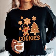 This Cute Gingerbread Man Cookies Holiday Sweatshirt exudes warmth and holiday cheer. Perfect for cozying up during the colder months, this medium-heavy fabric blend sweatshirt offers a comfy fit with a crew neckline. The adorable gingerbread man cookies design brings a festive vibe to your outfit, making it ideal for holiday gatherings and Christmas celebrations. The unisex design appeals to anyone looking to spread some holiday joy. Product features - Medium-heavy fabric blend for coziness - Classic fit with crew neckline for comfort - Double-needle stitching for durability - Ethically grown and sustainable materials - Adorable gingerbread man cookies design Care instructions - Machine wash: cold (max 30C or 90F) - Non-chlorine: bleach as needed - Tumble dry: low heat - Do not iron - Do Gingerbread Man Clothes, Gingerbread Sweatshirt, Festive Christmas Crew Neck T-shirt, Winter Holiday Outfits, Men’s Christmas Jumper, Christmas Novelty Crew Neck T-shirt, Festive Cookies, Gingerbread Man Cookies, Xmas Sweater