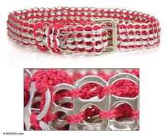 a close up of a bracelet with metal buckles and red beads on it's side