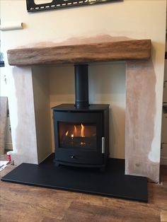 a wood burning stove in a living room with a sign on the wall above it