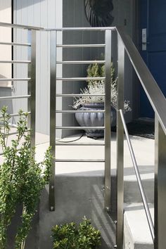 an outdoor area with potted plants and metal railings