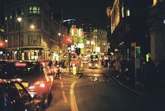 a city street filled with lots of traffic at night