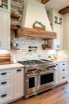 a stove top oven sitting inside of a kitchen next to white cupboards and drawers