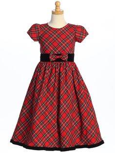 DetailsRed and black plaid holiday dress with round neckline and short cap puff sleeves. Black velvet waistband with plaid bow in front and long tie back sash. Zipper back closure. Full plaid skirt with velvet trim at the bottom. Dress is fully lined and includes a layer of crinoline for added fullness in the skirt. Tea length. Available in the following sizes: 4, 5, 6, 7, 8, 10, 12 Outer Polyester/Rayon Lining 100% Polyester Also available in green and blue plaid Made in the USA by Lito Childre Plaid Christmas Dress, Girls Christmas Dress, Red Holiday Dress, Red Plaid Dress, Girls Holiday Dresses, Girls Christmas Dresses, Darling Dress, Velvet Trim, Holiday Dress