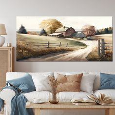 a living room with a white couch and painting on the wall above it's coffee table