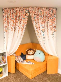 an orange couch with two stuffed animals on it