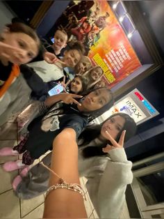 a group of young women standing next to each other in front of a movie poster