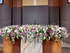 flowers are placed on the back of a church alter