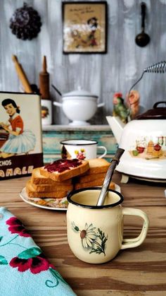 a table topped with plates and cups filled with cake on top of wooden counter tops