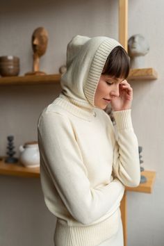 Get ready to confront unexpected rain, wind, and snow, but be sure this knitted hoodie will get your covered. Made from extra fine merino wool, this minimalist handmade balaclava will keep you cozy and toasty. It keeps your hair in place, be it a wash day or a bad hair day. It also goes with everything. Pair it with a puffer coat, oversized overcoat, or any hoodless piece of outwear as soon as the temperatures drop and you are set to go. There is no doubt you would easily pick the right color to Winter Beige Knit Bonnet, Cozy Cream Winter Bonnet, Winter Merino Wool Knit Beanie, Fitted Bonnet For Cold Weather And Winter, Warm Cream Bonnet For Winter, Winter Knit Fitted Bonnet, Cream Knitted Bonnet For Winter, Cream Knit Bonnet For Winter, Winter Cream Knit Bonnet