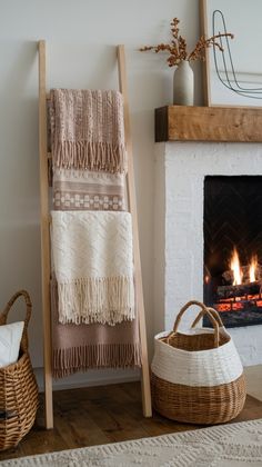 a fireplace with blankets and baskets next to it