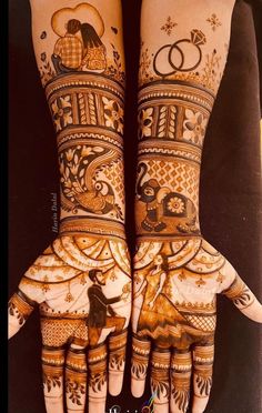 two hands with henna designs on them