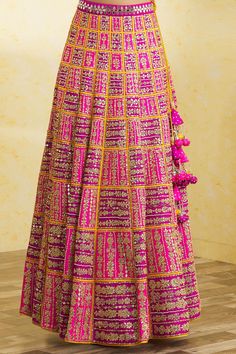 Fuchsia, purple and yellow colorblock lehenga with attached cancan, gota and mirror work embroidery in geometric boxes with floral patterns. Comes with embroidered, padded blouse and dupatta.
Component: 3
Pattern: Embroidered
Type Of Work: Mirror and Gota Work
Neckline: Plunged V-Neck
Sleeve Type: Short
Fabric: Dupion Silk
Color: Purple, Yellow, Fuchsia
Other Details: 
Back scoop neck blouse with tassel tie-up
Side tassel tie-up lehenga
Embroidered border dupatta
Lehenga with attached cancan
Pad Mirror Work Embroidery, Geometric Box, Purple Mirror, Fuchsia Purple, Gota Work, Padded Blouse, Scoop Neck Blouses, Embroidered Border, Dupion Silk