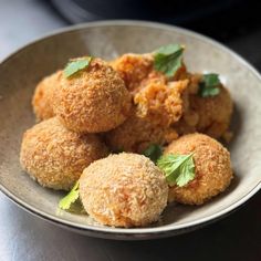 a bowl filled with fried food on top of a table