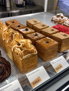 several different types of pastries on display in a case