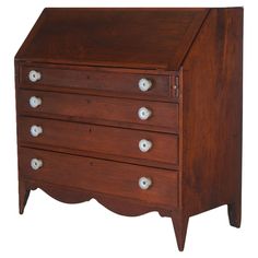 an old wooden dresser with drawers and knobs