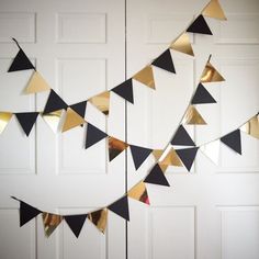 a bunch of black and gold flags hanging from the side of a door