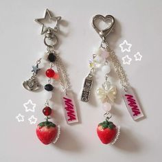 two key chains with charms attached to them