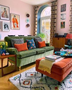 a living room filled with lots of furniture and pictures on the wall above it's windows