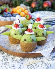 some kind of food that is sitting on a tray with fruit in the back ground