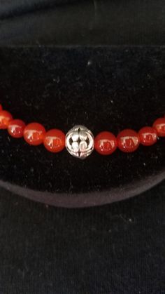 "This handmade Genuine Carnelian Beaded Bracelet was made on Silver Wire with round Genuine Carnelian Ball Beads. At each end are a 925 lobster clasp and jump ring. At the center is medium size Silver Ornate Metal Ball that is the focal point. This bracelet was handmade by Dulcinea for a small wrist and all items used are new. This bracelet will arrive in a gift box with FREE SHIPPING. Measure: 6 5/8\" L Material: Genuine Carnelian in Round Shape, 925 Lobster Clasp and Ornate Round Metal Ball Ha Earring Holder, Metal Ball, Carnelian Beads, Jewelry Holder, Small Birds, Enamel Jewelry, Gorgeous Earrings, Black Enamel, Gemstone Bracelet