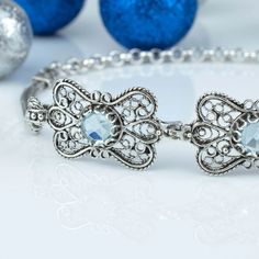 Make a statement with this stunning 925 sterling silver handmade filigree art butterfly design featuring a December birthstone blue topaz gemstone women's adjustable link bracelet. With 7.00 inches + 2.00 inches extension length, this bracelet is adjustable to fit any wrist size. Each gemstone is 6.00 mm round cut and beautifully complements the intricate butterfly design. Perfect as a gift option for special occasions, such as anniversaries, birthdays or thanksgiving. The blue topaz gemstone is Lace Cuff Bracelet, Sterling Silver Flower Earrings, Gemstone Cuff Bracelet, Art Butterfly, Silver Link Bracelet, Silver Flower Earrings, Filigree Jewelry, Bracelet Blue, Sterling Silver Filigree