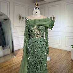 a green dress on display in a room