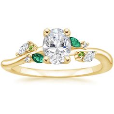 a yellow gold engagement ring with three stones on the band and an oval center stone