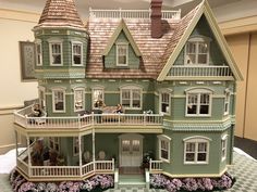 a large doll house with lots of windows and balconies on the top floor