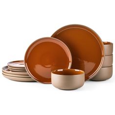 a stack of orange plates and cups on a white background