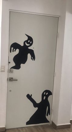 the door is decorated with black and white silhouettes of two cartoon characters on it