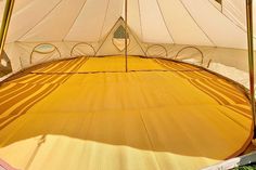 the inside of a tent that is set up on grass