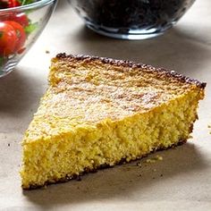 a piece of cornbread next to a bowl of fruit