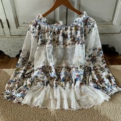 Add This Beautiful Floral Print & Lace Blouse To Your Summer Wardrobe. The Perfect Combo Of Flirty + Feminine. This Top Features A Wide Neck, Elastic Waist, & Puffy Sleeves. Put On A Tank Top Or Cute Bralette On Underneath. Sheer Material. 100% Polyester | Hand Wash Small | 2-4 Lace Tops With Floral Print For Daywear, Lace Floral Print Tops For Daywear, Spring Lace Patchwork Tops, Bohemian Lace Top With Floral Print, Spring Brunch Tops With Lace Patchwork, Spring Brunch Lace Patchwork Top, Spring Lace Blouse With Lace Patchwork, Lace Patchwork Blouse For Spring, Beach Lace Tops With Floral Print