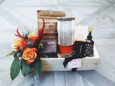 a wooden box filled with lots of different types of items on top of a table