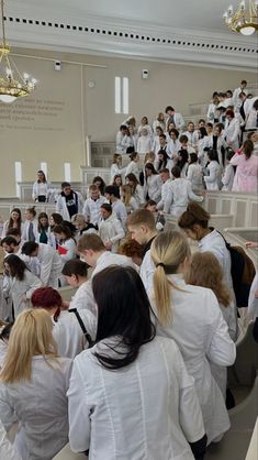 a large group of people in white lab coats