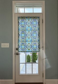 an open door with a blue and green window covering