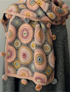 a crocheted bag hanging from the back of a mannequin