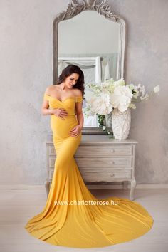 a woman in a yellow dress posing for the camera with her hand on her hip