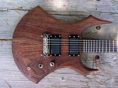 an electric guitar sitting on top of a wooden table