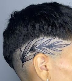 a close up of a person's head with a tattoo on the side of his head