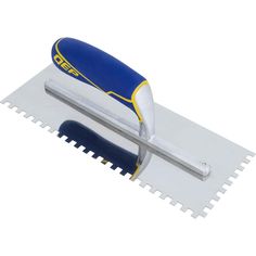 a blue and white trowel laying on top of a piece of plastic material