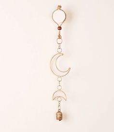 a metal wind chime hanging from a wall