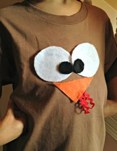 a person wearing a brown shirt with a turkey face on it