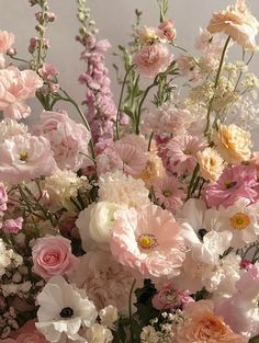 a vase filled with lots of pink and white flowers