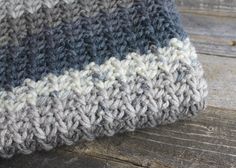 a knitted hat sitting on top of a wooden table