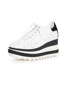 Expertly crafted with a perforated monogram-patterned upper and an elevated, striped wedge heel, these sneakers offer a stylishly unique touch. Synthetic and textile upper Square toe Lace-up vamp Striped accent Textile lining Lightly padded insole Synthetic sole Made in Italy SIZE Wedge heel, 3" (76mm) Platform, 2" (51mm) Style Code: 0400016474641 Sporty White Wedge Heel Platform Sneakers, Modern Platform Sneakers With Wedge Heel, Modern Wedge Sneakers With White Sole For Spring, Trendy White Platform Sneakers With Perforations, Modern High-top Wedge Sneakers With Perforated Toe Box, Sporty Wedge Heel Sneakers For Spring, Modern White Wedge Sneakers With Rubber Sole, Designer Low-top Platform Sneakers, Platform Wedge Heels